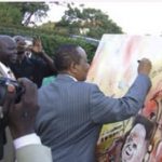 Roland Birutsya and Dr. Tumusiime Mutebire, Governor Bank of Uganda signing painting