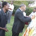 Uganda Prime Minister, Prof. Apollo Nsibambi signing one of Birutsya’s paintings